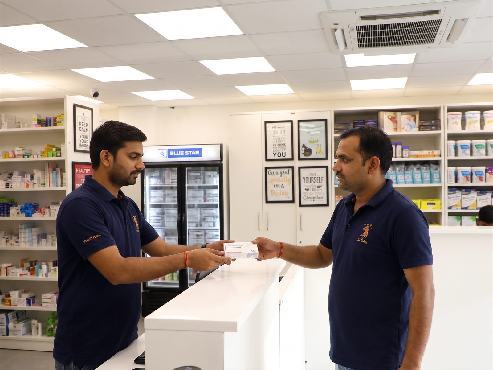 Chemist Box pharmacist serving a customer one-on-one